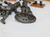 figurines of a group of men laying on top of a table