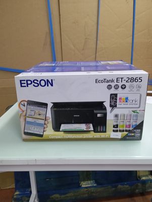 a box with a printer and a cell phone on a table
