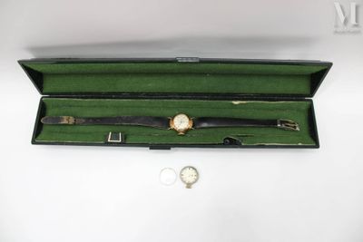 a watch and a watch in a case on a table