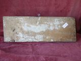 an old piece of wood sitting on top of a red cloth