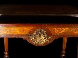 a wooden table with a gold decoration on it