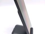 a cell phone sitting on a stand on a white surface