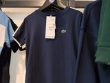 several t - shirts hanging on a rack in a clothing store