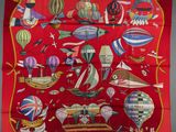 an image of a red scarf with many different types of hot air balloons
