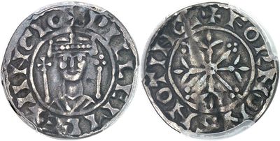 a close up of two silver coins on a white surface
