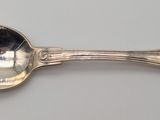 a silver spoon with a spoon handle on a table