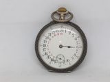 a close up of a pocket watch on a white surface