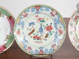 three plates that are sitting on a wooden table
