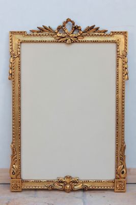 an antique gold frame with a decorative design on it