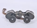 an old pair of binoculars sitting on top of a white surface