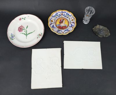 three plates, a glass vase, and a napkin are on a table