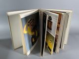 an open book with a picture of a yellow car on it