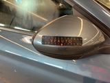 a close up of a car ' s side mirror with a sticker on it