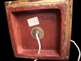 a small red box with a white cord attached to it