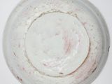 a white plate with a red spot on it