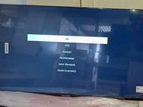 a flat screen tv sitting on a table in a room