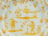 an orange and white plate with a picture of two people on it
