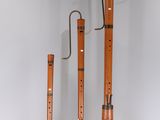 three flutes are lined up in a row on a white surface