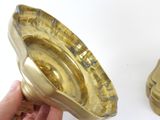 a person holding a gold object in their hand