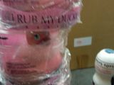a pile of pink donuts wrapped in plastic on a table
