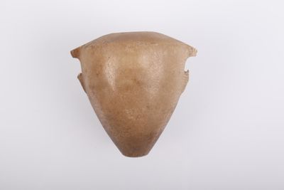 un gros plan d'un objet marron sur une surface blanche