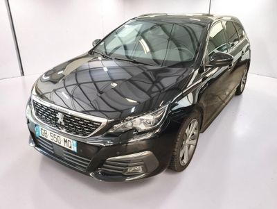 the black car is parked in a white room with a white floor