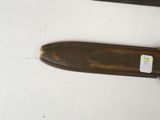 a knife that is laying on a table with a tag on it