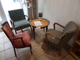 three chairs and a table in a room