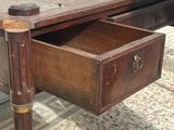 an old wooden desk with a drawer underneath it