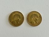 two gold sovereigns, one of which has a head of a man and one of which is a woman