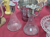 two glass vases on the table next to each other