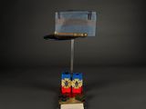 hat on a stand with two legos on top of it