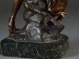 bronze statue of a woman holding a bird on a marble base