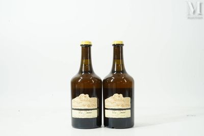 two bottles of wine sitting next to each other on a white surface