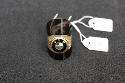 a ring with a bmw emblem on it on a table
