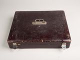 a brown suitcase sitting on a white surface