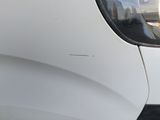a reflection of a building in the side mirror of a car