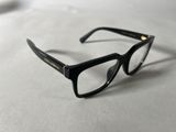 glasses on a table with a white table cloth and a pair of black glasses