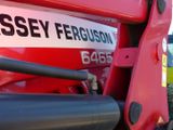 a close up of a red tractor with the name massey ferguson on it
