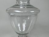 a clear glass jar with a lid on a table