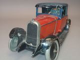 a toy model of a red car on a white surface
