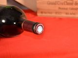 a bottle of wine sitting on a table next to a bottle of wine