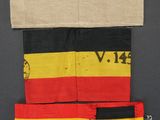a close up of a piece of cloth with a red, yellow and black stripe