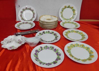 many plates that are sitting on a red table cloth