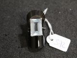 a small black object with a white tag on it