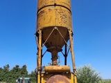 a large yellow water tower sitting in the middle of a yard
