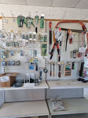 many tools hanging on the wall in the store