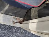 a close up of a car door with rust on it