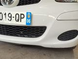 a close up of a white car with a license plate on it