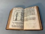 an open book with a drawing of a man standing on top of it